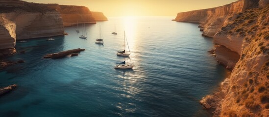 A group of sailboats are moored in a beautiful bay on the coast with two cliffs on the left and right sides