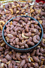 Skinned Cashews in a Decorative Bowl Close-Up View, Close-up image of skinned cashews in a decorative ceramic bowl, showcasing the texture and natural color variations of the nuts.
