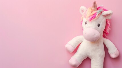 Obraz premium Plush unicorn toy with pink mane on background
