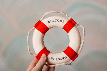 A small lifebuoy with red stripes, a perfect nautical decoration for coastal interiors.
