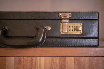 Briefcase with lock on the cupboard.