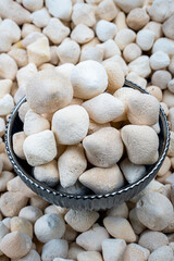 Sheep Curd Cheese Balls in Craft Bowl, Artisan Dairy Product, Close-up view of natural sheep curd cheese balls in a decorative metal bowl atop many other curd pieces.