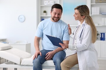 Fototapeta premium Professional doctor working with patient in hospital, space for text