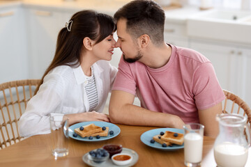 Lovely couple spending time together during breakfast at home