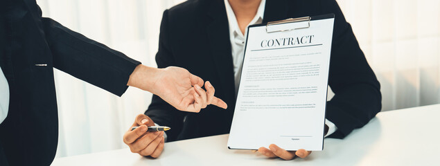 Business executive signing contract agreement document on the bale with the help from company...