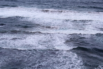 Close up of the ocean surface with waves and foam