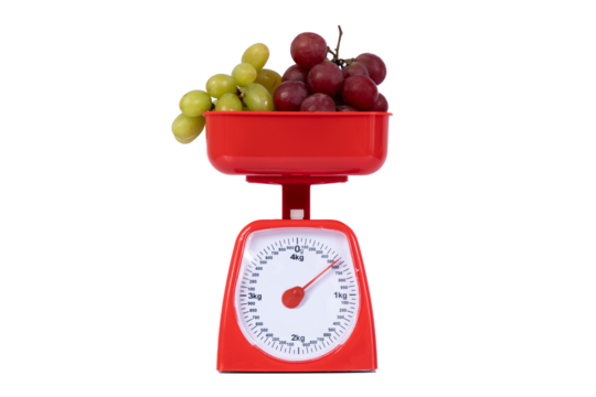 A scale to weigh food with grapes on it. Not background