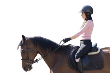 Close up of a young woman riding a horse in an equestrian center, while taking riding lessons