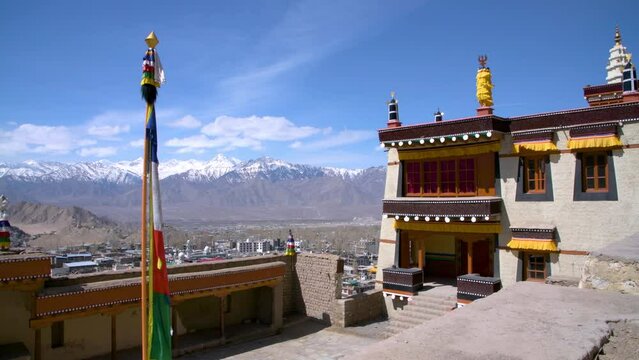 Historic Leh Palace with snow-capped Himalayas in the background in India's Ladakh region