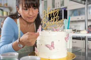 Baker making a birthday cake in her cafeteria