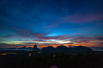 Fototapeta premium wonderful sunrise natural Landscape above Samed Nang Chee Phang Nga viewpoint. .amazing bright sky at twilight. Beautiful sunrise tropical landscape background..popular landmark of Phang Nga