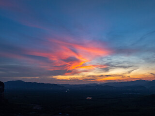 Obraz premium aerial view Beautiful pink cloud at sunset above mountain range in Phang Nga. .High peaks wonderful sunset natural Landscape. .Beautiful sunset tropical landscape background.