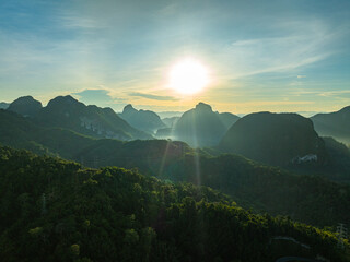 aerial hyper lapse view Amazing light of nature cloudscape above mountain range in Phang Nga. .High peaks wonderful morning sunset natural Landscape. .Beautiful sunset tropical landscape background..
