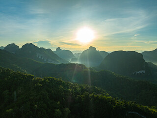 aerial hyper lapse view Amazing light of nature cloudscape above mountain range in Phang Nga. .High peaks wonderful morning sunset natural Landscape. .Beautiful sunset tropical landscape background..