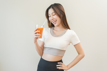 Orange detox juice, smile asian young woman hand holding a glass of vegetable juice, carrot...