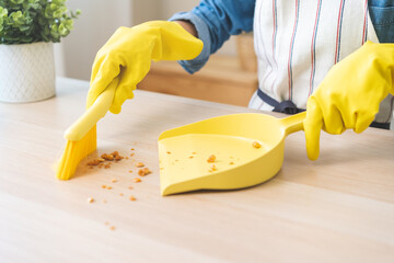 Household clean up, housekeeper asian young woman wearing protection rubber yellow gloves, using...