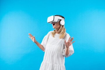 Skilled girl in pajamas excited with metaverse by using VR goggle at background. Caucasian woman...