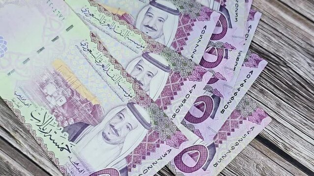 5 SAR five Saudi Arabia riyals cash money banknote bill series 1441 AH features Shaybah oil refinery in Rub' al Khali and king Salman Bin AbdulAziz Al Saud, exchange rate and money value concept