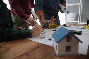 Diverse Team of Specialists Use Laptop on Construction Site. Real Estate Building Project with...