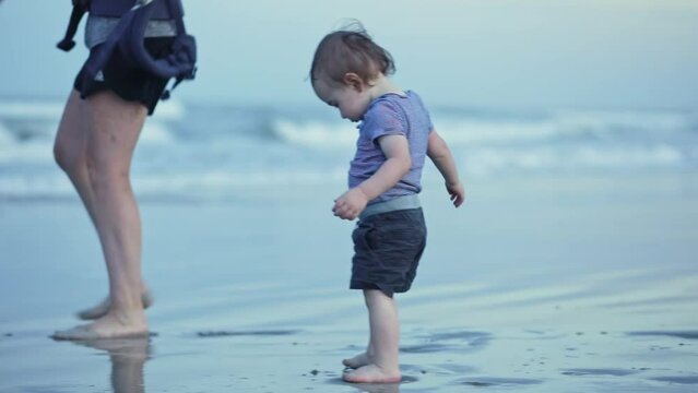 Toddler Boy Child Walking first steps, family parent, Beach water shoreline, night Dusk