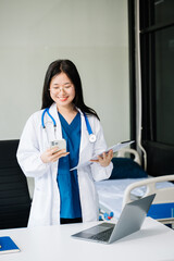 Beautiful physician doctor sit on table in office hospital. Attractive therapist female...