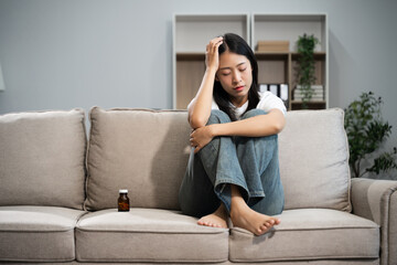 Obraz premium woman sit Depression Dark haired pensive glance Standing by window on sofa and anxiety