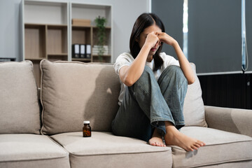 Obraz premium woman sit Depression Dark haired pensive glance Standing by window on sofa and anxiety