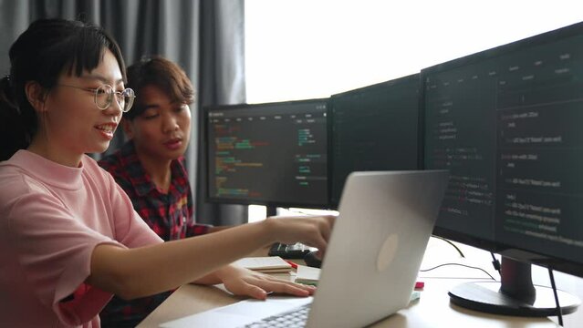 Back end software developer engineer for computer programming working together on debugging writing computing code, solving complex algorithms display on monitor in office. Burgeoning