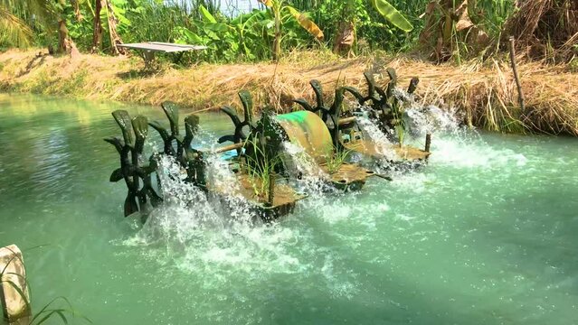 Small water purification machine working in a small canal farming at an organic farm in Thailand.