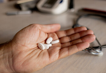 Close-up of a doctor's hand showing the prescribed medicine. Health care.