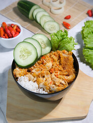 Spicy Crispy Chicken Rice Bowl with Cucumber & Chili Garnish