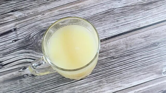 A glass of Guava juice, a common tropical fruit cultivated in many tropical and subtropical regions, The common guava Psidium guajava (lemon guava, apple guava), a small tree in the myrtle family
