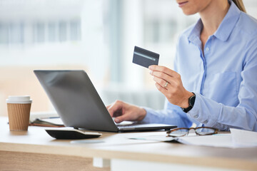 Business woman, laptop and hands with credit card for online shopping, ecommerce and purchase on website at work. Office, desk and internet payment at company on a digital store deal and web sale