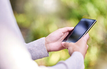 Outdoor, hands and woman with smartphone, nature and typing with social media, screen and connection. Closeup, person and girl with cellphone, mobile user and internet with online reading and app