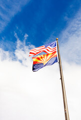 Design Waving American USA Flags and Flag of Arizona State on Flagpole On Background Of Blue White Sky, Template Vertical Plane, Copy Space.