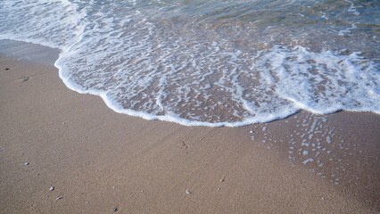 Beautiful Soft blue ocean wave on fine sandy beach Summer background concept