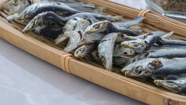 Image for background of anchovies on a straw plate. Japanese style dried small fish. niboshi