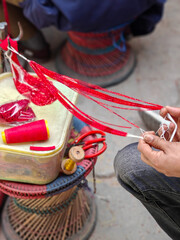 Making strands of colorful beads at an outdoor market in Kathmandu