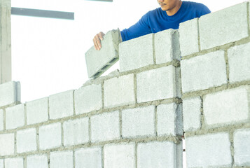 Mansonry install concrete brick for wall of dormitory.
