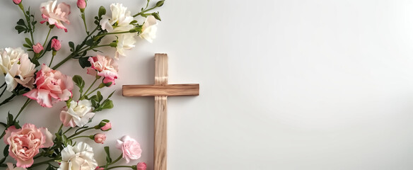 Composition with a Christian wooden cross and flowers against mu