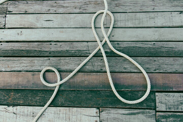 Obraz premium Rope on a wooden background