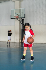 basketball by asian child or kid girl fun playing and training to learning bouncing and raising...