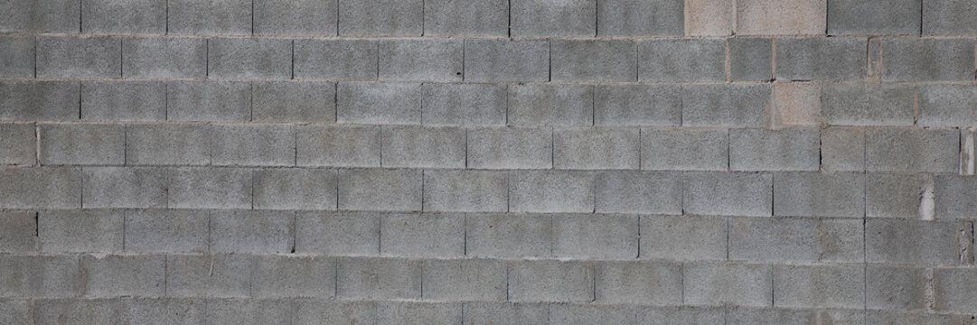 old gray cement background with cinder block wall