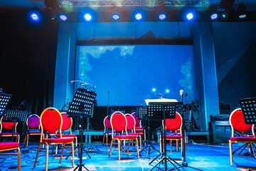 Preparing for the concert performance - stage with musical instruments under bright spotlights