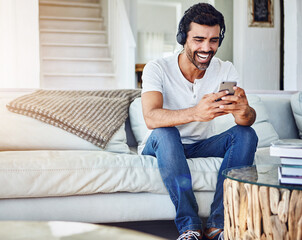 Man, headphones and laughing with phone in home for funny video, social media post and comedy movie...