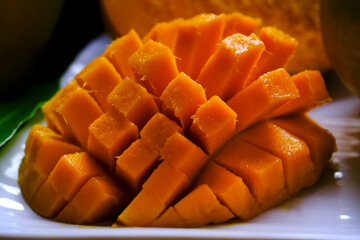 Mango tropical fruit with green leaf, Ripe mango in grass closeup