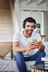 Man, headphones and laughing with phone on sofa for funny video, social media post and comedy movie on mobile app. Person, smartphone and happy for listening to audio, sound and subscription in home