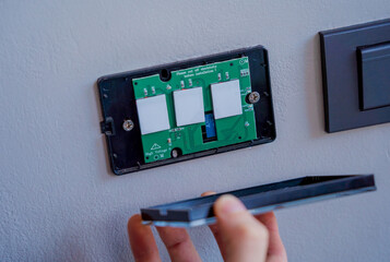 Technician installing sensor light switch at modern villa
