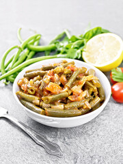 Beans green with vegetables in bowl on stone tabletop
