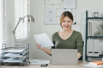 Young businesswoman working from home with laptop and documents. Work life balance concept
